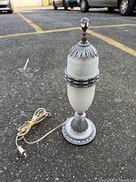Full view of chrome and frosted glass table lamp with cord visible