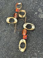 full view of sculpture showing layout of rings, squares and disc