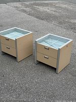 Pair of beige vinyl display cabinets on pavement