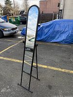 Front view showing arched mirror and metal frame