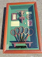 Full view of framed shadowbox on ground showing all contents