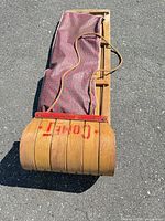 Top view of folded Comet bentwood sled showing plaid seat and overall length