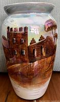 Front view of ceramic vase with castle scene