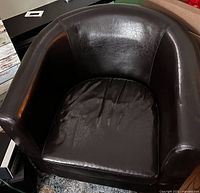 Front angled view of brown faux leather tub chair