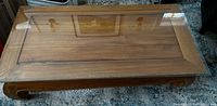 top view of teak wood coffee table with glass inset