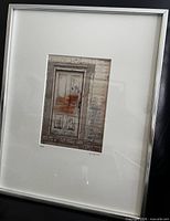 Framed photograph in silver frame with white mat
