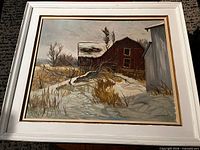 Full view of framed barn winter scene painting