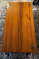 Top view of closed pine trunk showing wood grain and hinges