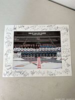 Full view of team photo print with facsimile signatures