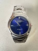 Front view of Armitron watch showing blue dial and diamond marker