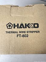 Closed cardboard box showing Hakko branding and model number FT-802