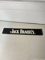 Front view showing Jack Daniel's logo on textured mat surface