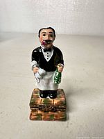 Front view of waiter figurine on hinged base