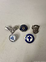 Group shot of all five pins showing design and scale