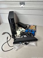 Full bundle showing console, controllers, Kinect, power supply, cable and game