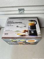 Sealed box showing Pampered Chef Deluxe Cooking Blender model 100125