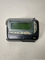 Front view showing Unication branding, LCD screen, control buttons, American Messaging mark