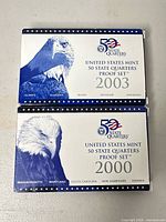 Front of both proof set boxes showing eagle artwork and 2003/2000 labeling