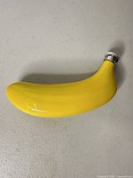 Front view of yellow ceramic banana flask showing shape and color
