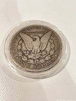 Reverse of 1890-O Morgan Dollar in capsule
