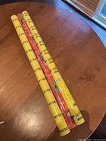 Three sealed gift-wrap rolls on table