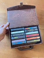Open carrying case showing twelve cassettes arranged in rows