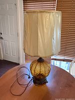 Full lamp with shade and cord visible