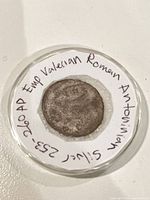 Coin in capsule with handwritten identification ring