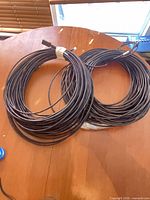Two coiled black Cat6 cables on tabletop