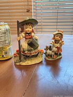 Front view showing both figurines side by side for scale and condition