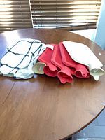 Group of five hot water bottles and two fabric covers on table