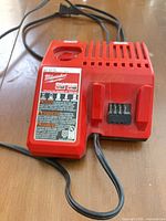 Top view of red Milwaukee M12/M18 charger showing label and battery ports