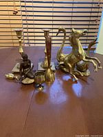 Group shot of all eight brass/bronze items on table