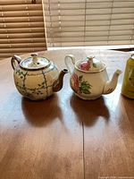 Both Gladstone teapots side by side