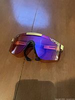 Front view of Pit Viper wraparound sunglasses on table