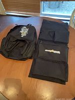 Backpack and organizer panel side by side on table