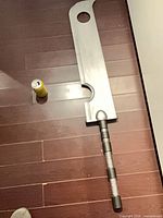 Full view of foam sword on floor with beverage can for scale