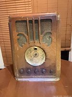Front view of Silvertone wooden tube radio showing grille, dial and knobs