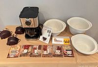 Overall group shot showing coffeemaker, manual, plaques, metal cup ornaments and three nesting bowls