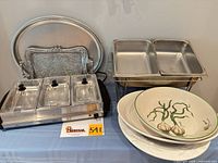 Front view showing electric warmer, chafing stand, bowls, and trays