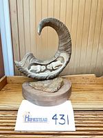 Full view of horn sculpture on base