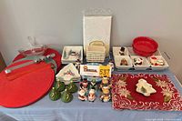 Wide view showing placemats, bowls, plates, shakers, tray and boxed tablecloth