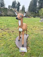 front view of painted concrete doe deer on base, note scale and surface wear