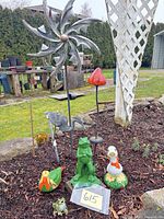 Group shot showing all yard art pieces together in garden bed