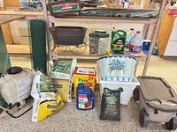 Overall view of lot on shelving with sprayer, bags, planters, chemicals, rolling seat