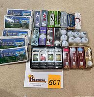 Overall lot showing rain hoods and assorted boxed golf balls