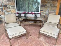 Full view of two chairs, two ottomans, coffee table
