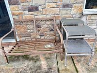 Hampton Bay metal settee and stack of side stools on patio