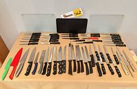 Entire lot laid out: cutting boards, full knife assortment and honing steels