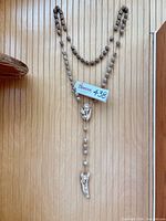 Full view of hanging wall rosary on panelled wall